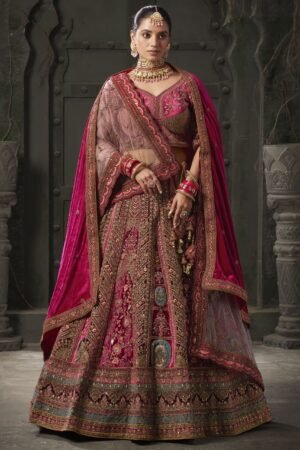 Indulge in the regal allure of this magnificent maroon color velvet bridal lehenga, meticulously crafted to adorn the bride in timeless elegance and sophistication. Luxuriously crafted from sumptuous velvet material, this ensemble is adorned with a mesmerizing array of embellishments, including multi-thread work, sequin work, diamond work, zari work, velvet embroidered patchwork, and fancy dori work, ensuring a breathtakingly opulent aesthetic. Accompanying the lehenga is a matching velvet choli, intricately detailed with similar multi-thread work, sequin work, diamond work, zari work, embroidered work, and fancy dori work, creating a harmonious and refined ensemble. The semi-stitched design of the lehenga offers a comfortable fit of up to 42 inches, allowing for ease of movement and flexibility. Additionally, the un-stitched choli material provides the opportunity for customization, ensuring a tailored and flattering silhouette for the bride. Completing the ensemble are two double dupattas crafted from similar maroon net and velvet material, adorned with exquisite lace work and butta work on all four sides. These dupattas add an ethereal touch of romance and grace, draping gracefully over the shoulders and enhancing the overall beauty of the bridal look. Whether worn traditionally or styled in a modern manner, these dupattas add a layer of sophistication and glamour to the ensemble. Draping yourself in this featured maroon color velvet bridal lehenga is not merely about wearing a garment; it's about embodying a sense of timeless beauty and refinement. Each element of this ensemble has been thoughtfully curated to ensure that the bride radiates confidence and grace on her special day. Prepare to receive an abundance of compliments as you showcase your impeccable taste and sophisticated style with this breathtaking bridal lehenga, destined to make you the epitome of elegance and grace on your wedding day. Disclaimer: Slight color variation may occur due to photographic reasons.